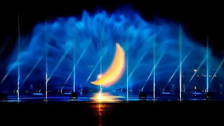 a vertical water screen with a moon shape projected onto it.