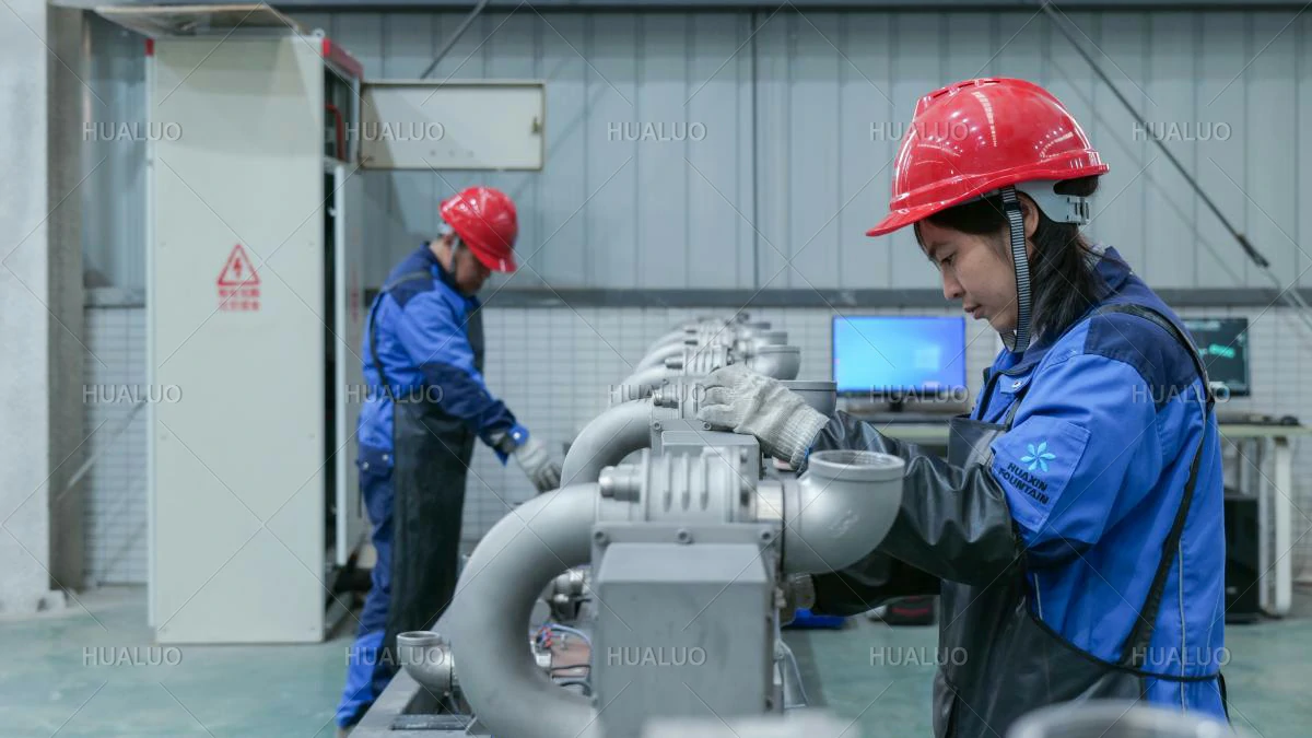 A worker inspecting the exterior finish of a fountain equipment unit.