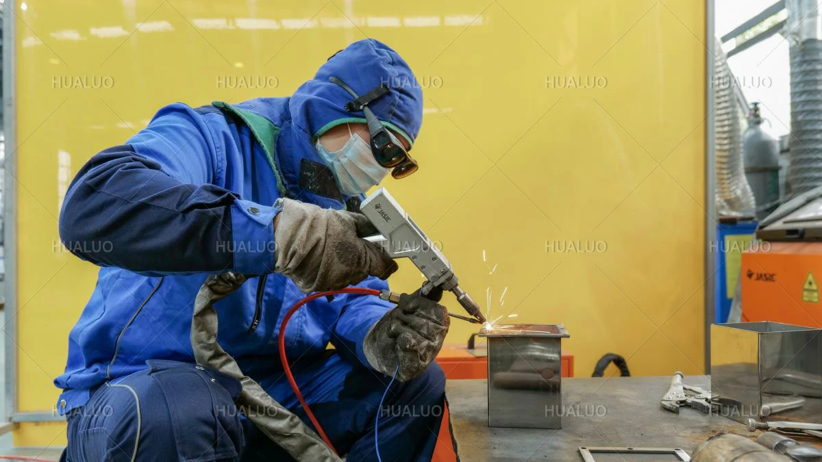 A worker welding components for fountain equipment.